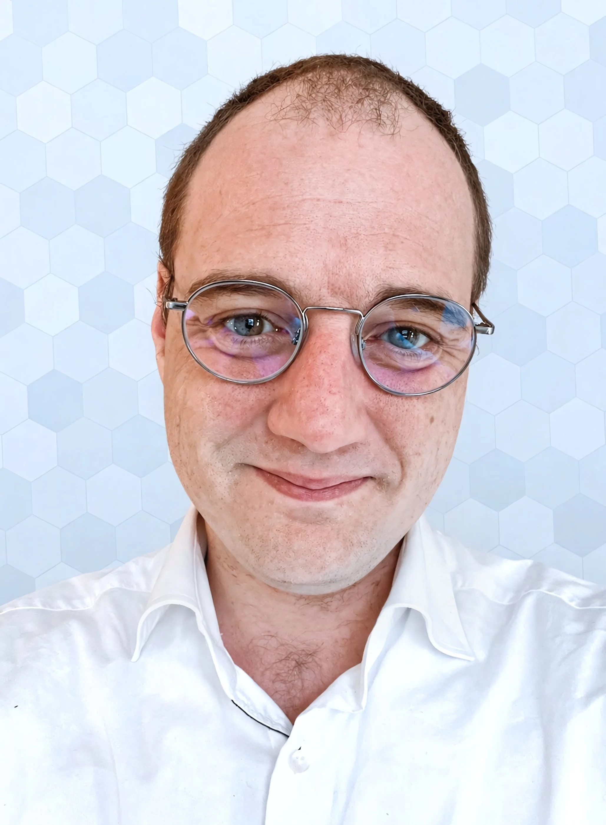 A selfie of a male on a hexagon background