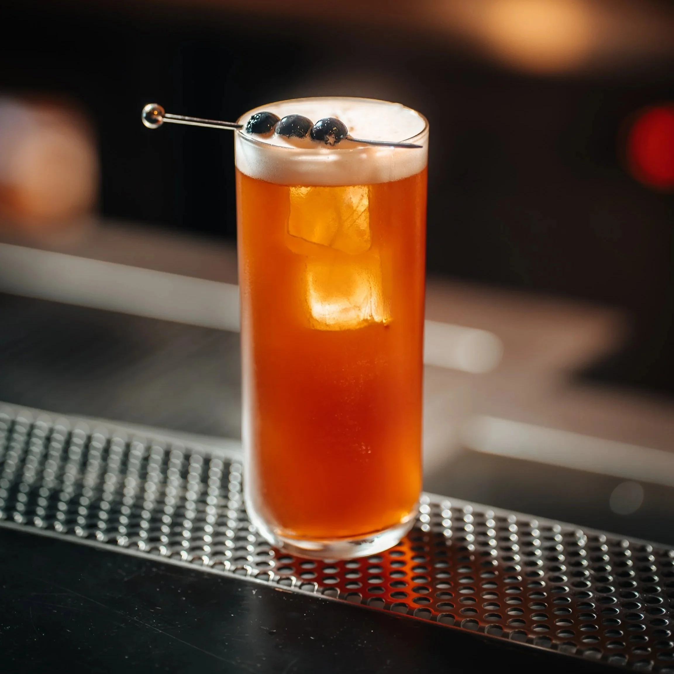 Freshly made cocktail No Jack No Coke on a bar counter at BAZ