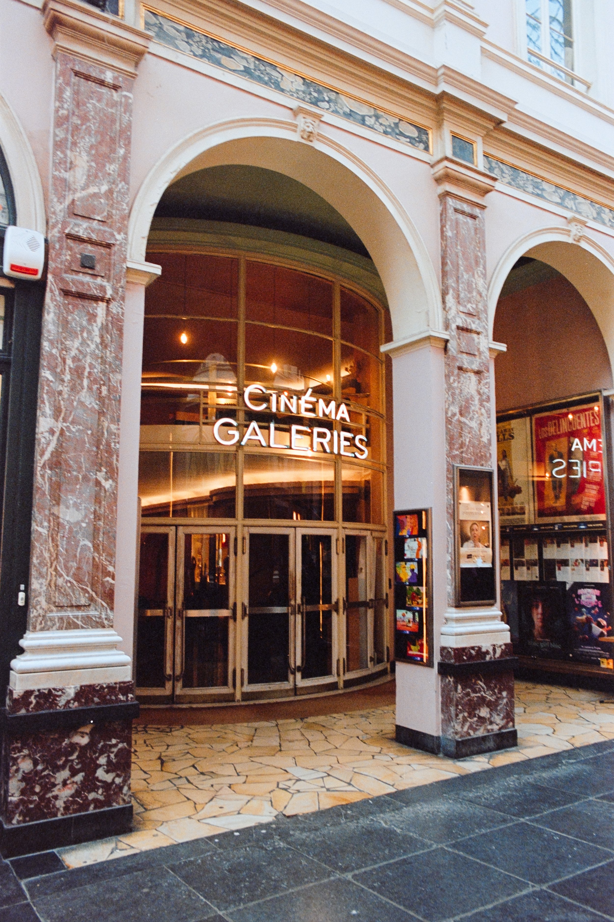 Fine art travel photography of Cinéma Galeries in Galeries Royales Saint-Hubert, Brussels. Showcasing the cinema's elegant architecture, illuminated signage, and cultural significance within a historic European gallery. Ideal for luxury prints and co