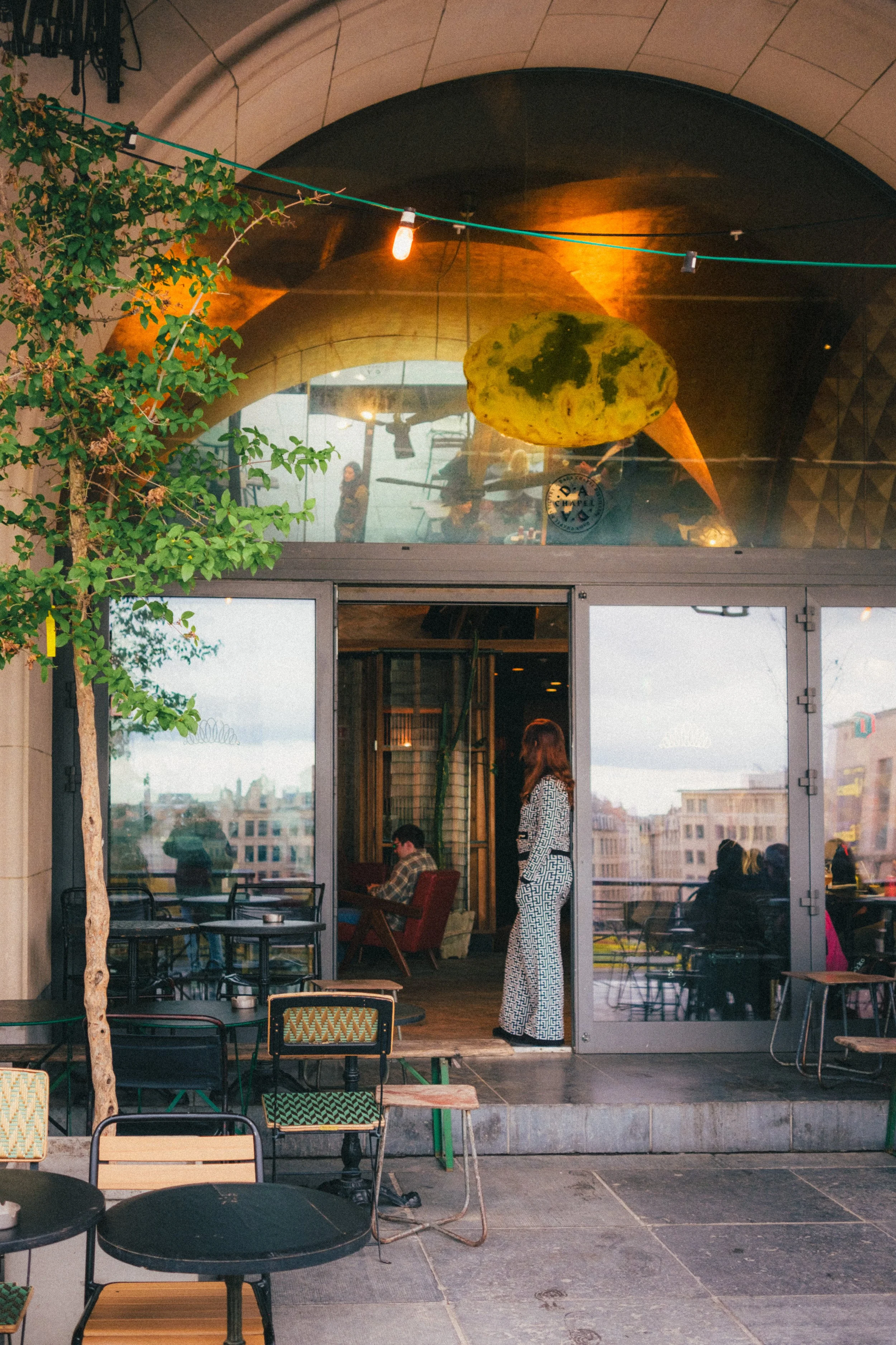 Artistic photograph of a stylish café in Brussels with a modern architectural design, capturing vibrant European café culture, unique interiors, and urban sophistication, perfect for fine art photography prints and gallery collections.
