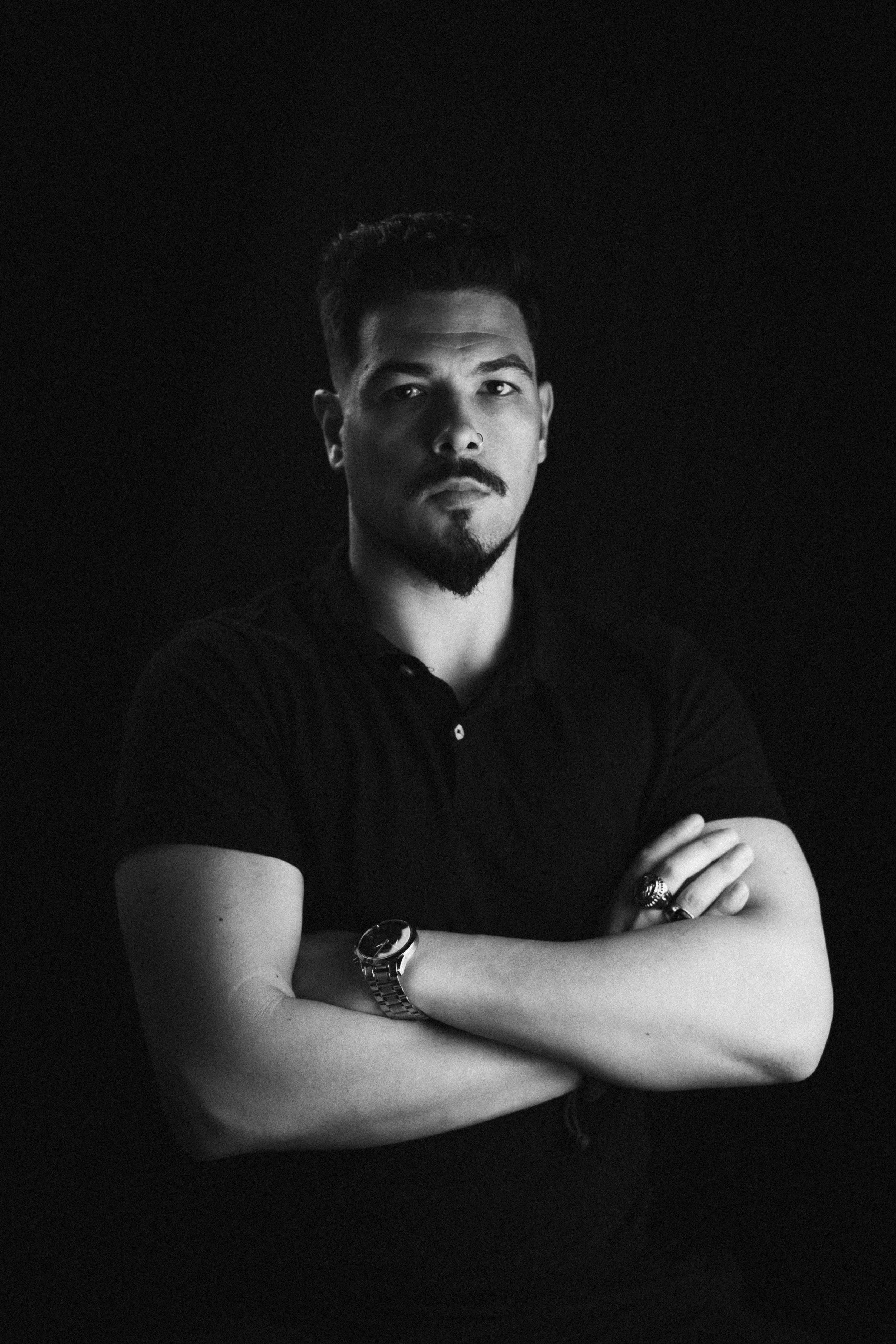 Black and white self-portrait of João Marques in profile, illuminated by soft lighting."