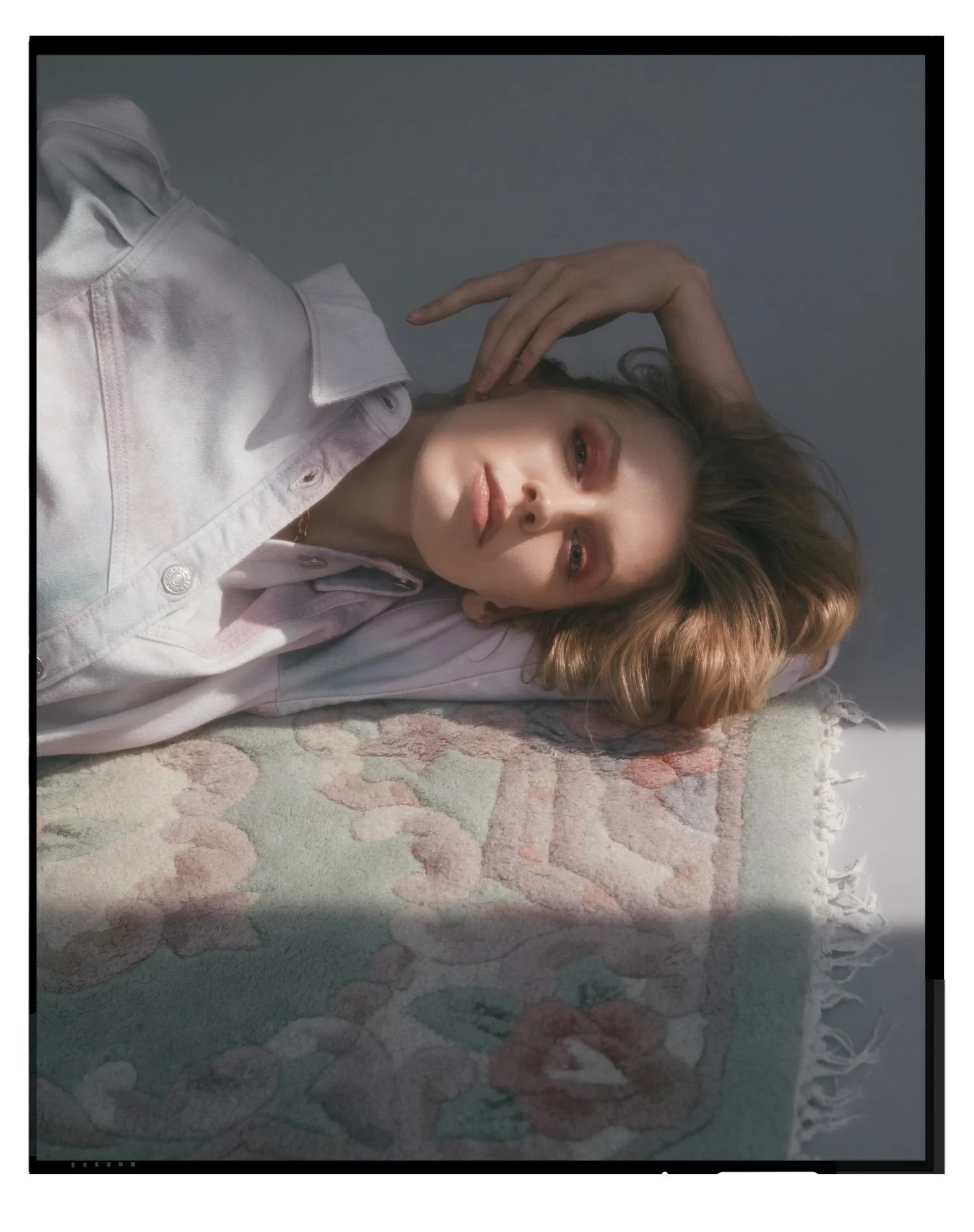 Denim editorial for Latest Magazine: pastel shirt lying on floral bedding