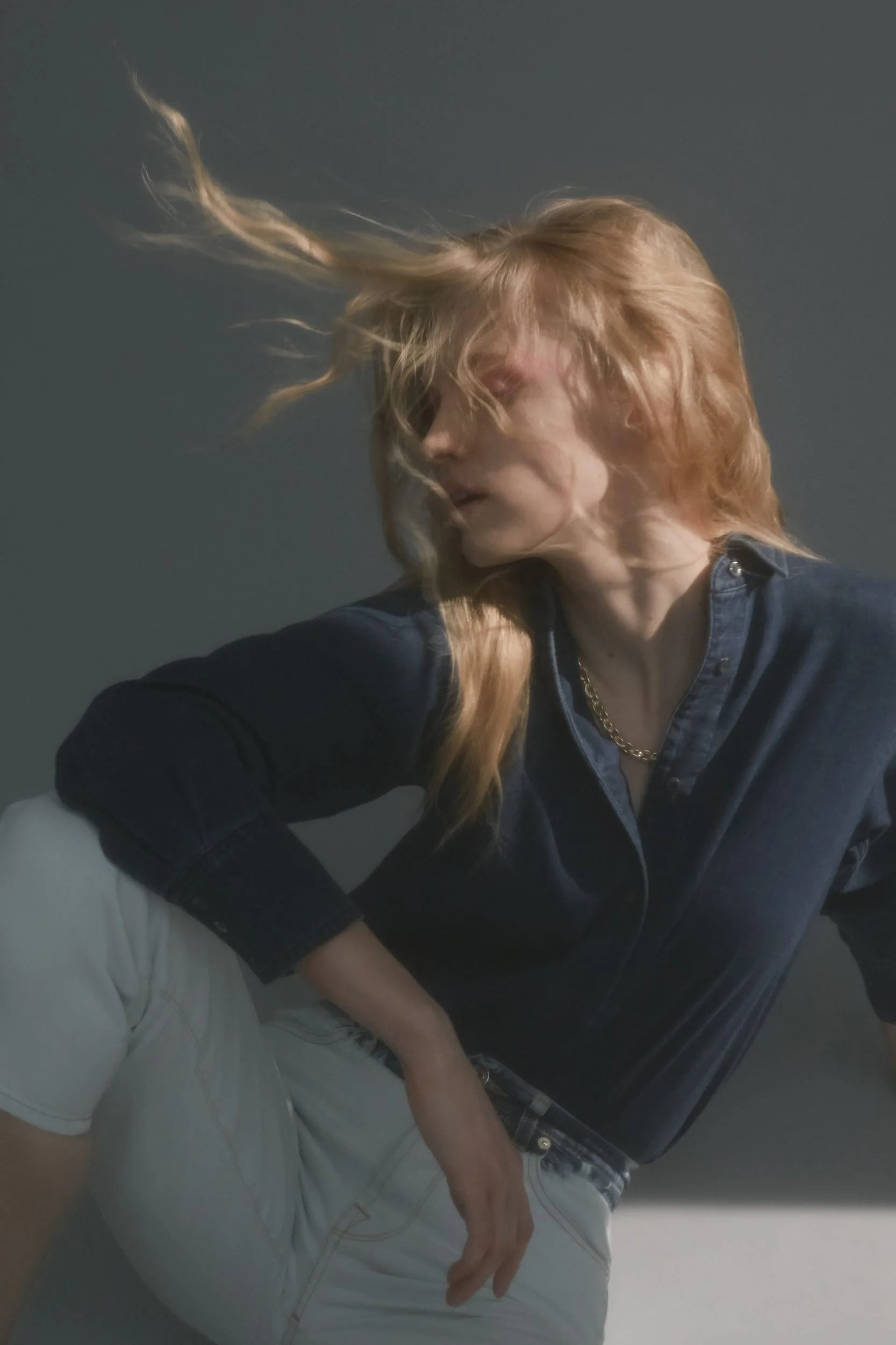 Denim editorial for Latest Magazine: hair in motion, navy top over denim