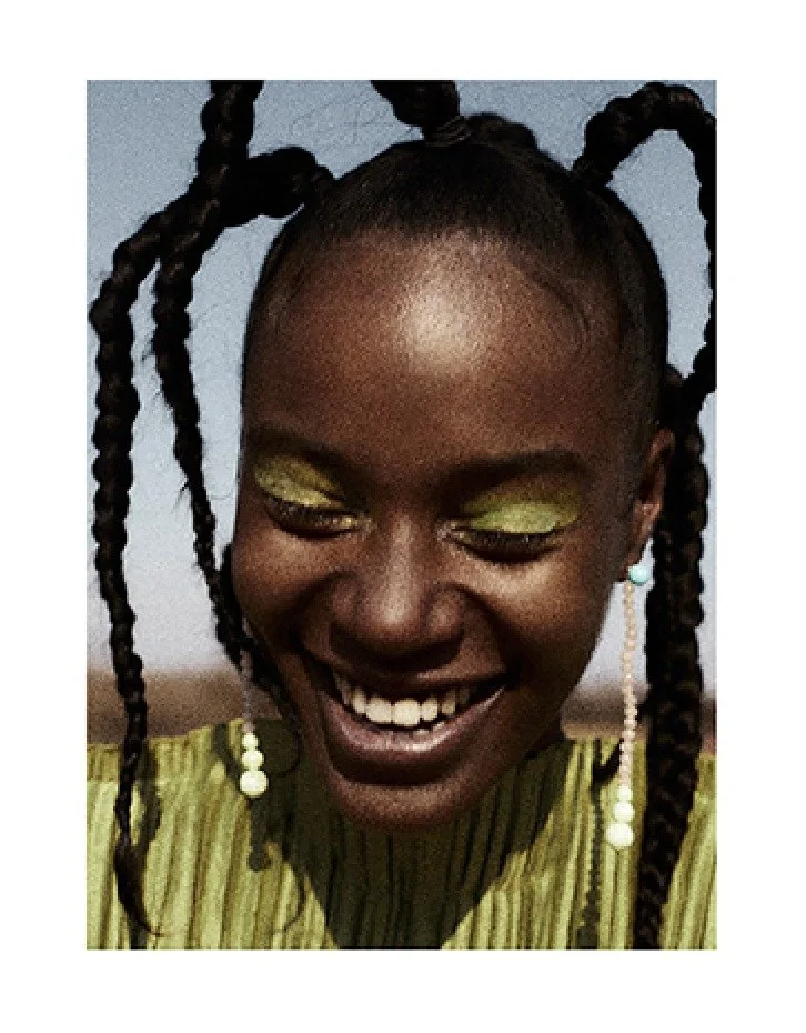 Beauty portrait with green eye make-up and braids