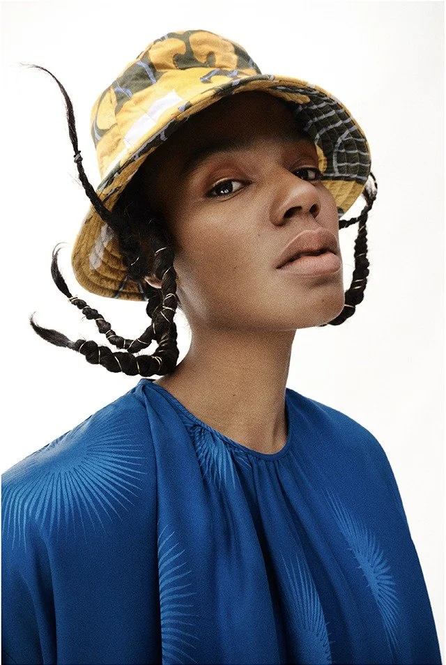 Portrait with a yellow bucket hat and a blue dress