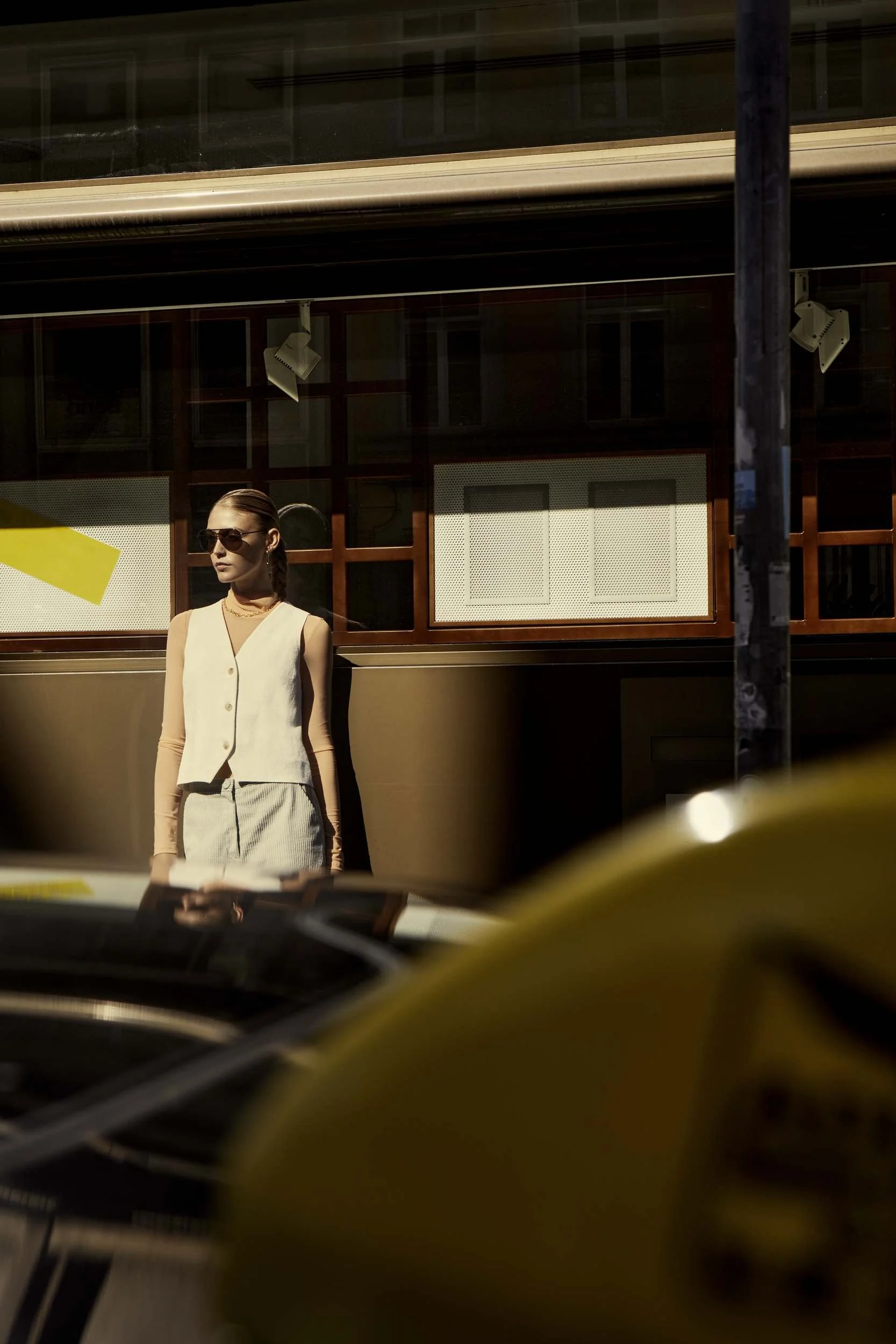 Beige suit reflected in a tram window