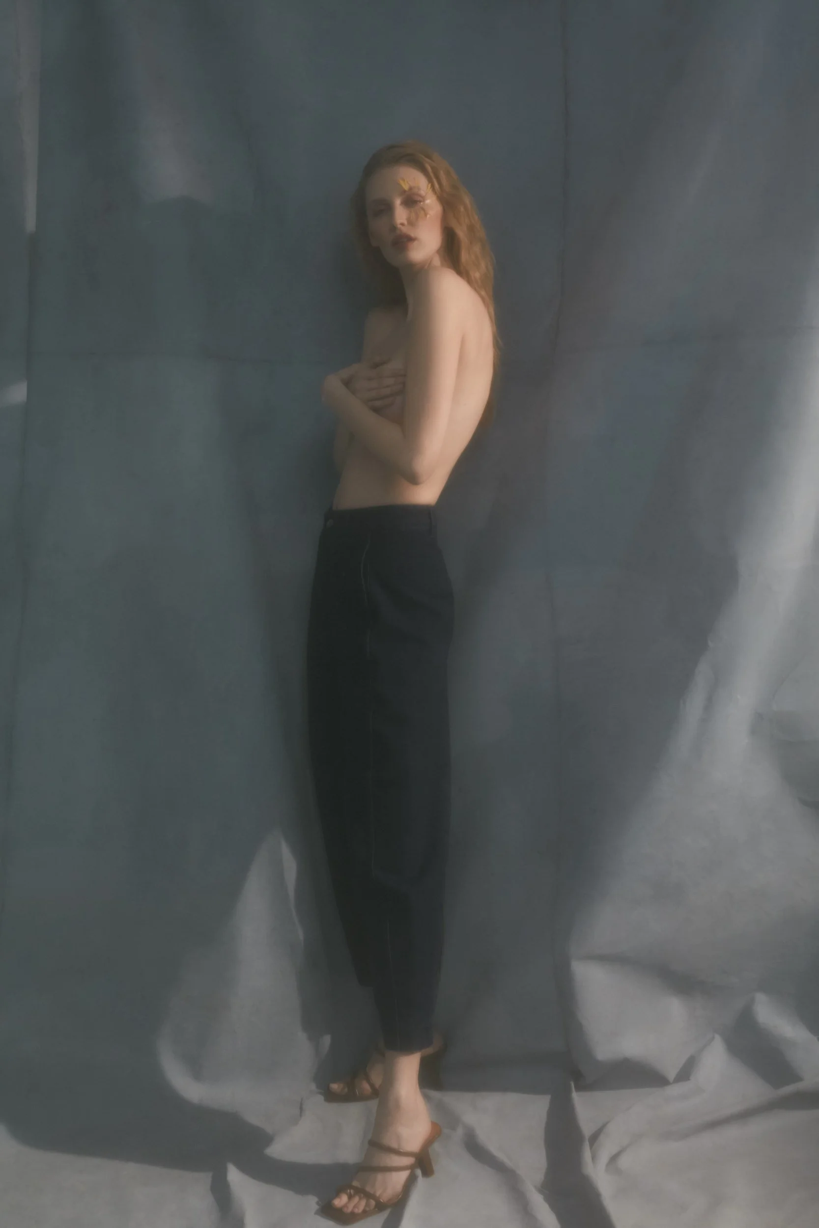 Denim editorial for Latest Magazine: black skirt with a bare back, standing