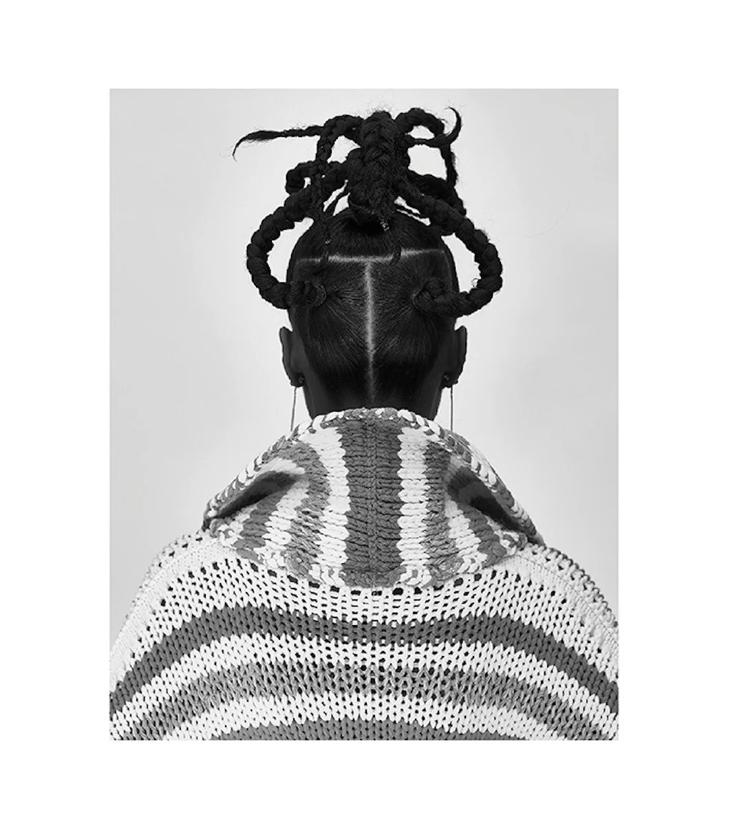 Knitted top with braided hair, seen from behind