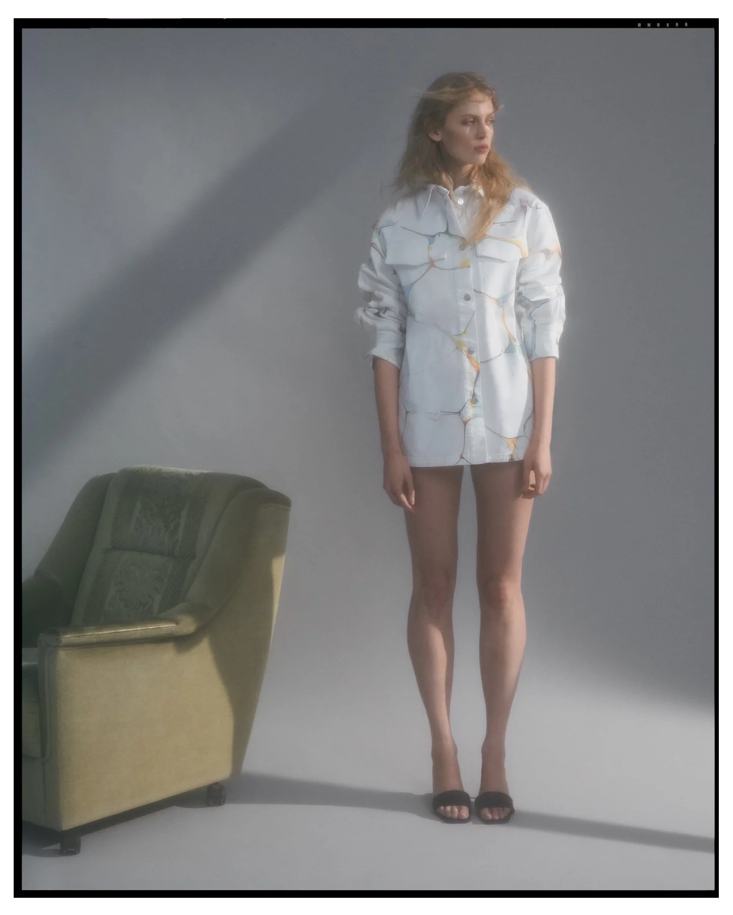 Denim editorial for Latest Magazine: light denim shirt dress beside a green armchair