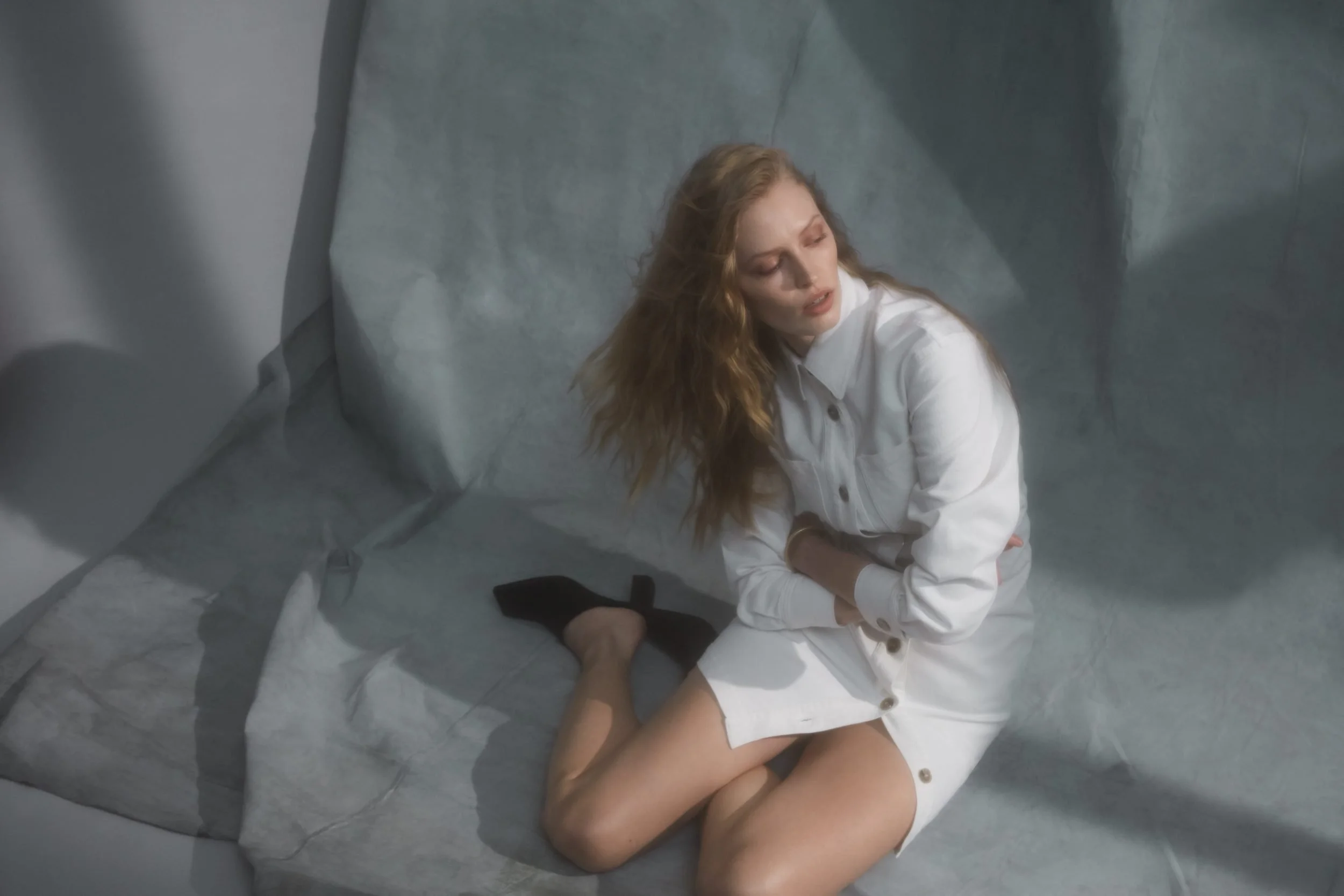 Denim editorial for Latest Magazine: white denim shirt, seated on a sofa, styling Anita Bauer
