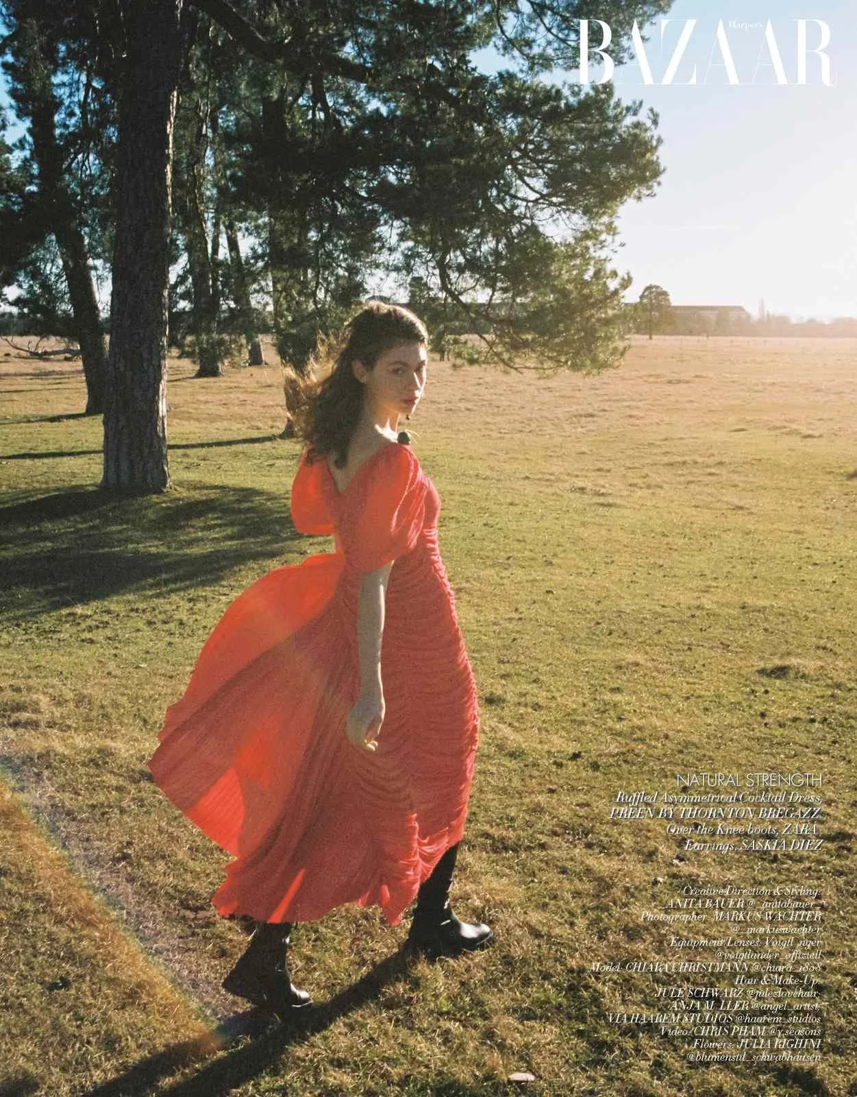 Harper's Bazaar Vietnam editorial: red flowing dress walking through a field at sunset
