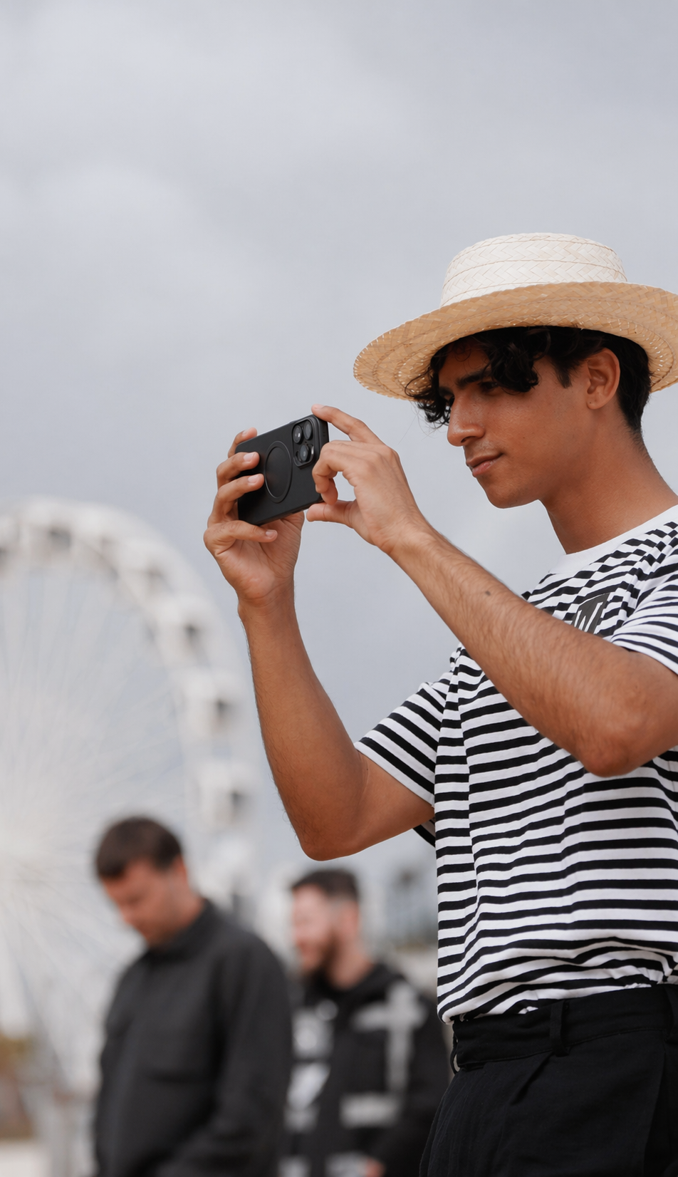Young man capturing a moment at the fair.png