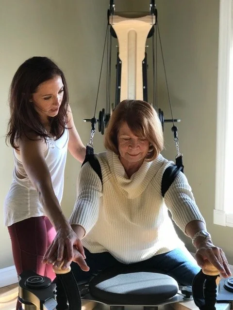 Instructor cueing a client during a GYROTONIC® session, posture and alignment coaching for shoulder stability, back pain relief, and healthy aging in Henderson, Nevada
