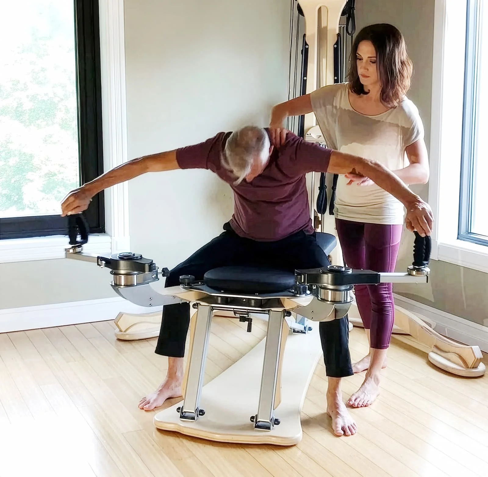 Kerri Affronti cueing posture and shoulder mobility for an older male client during a GYROTONIC® private session in Henderson, Nevada, supporting back pain relief and healthy aging