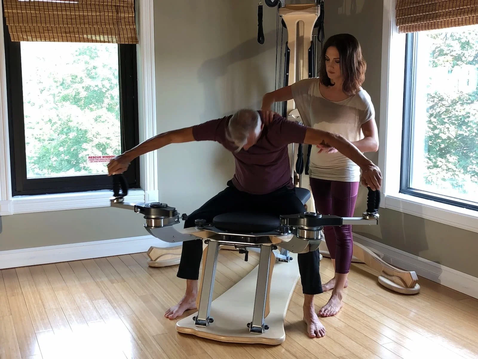 Kerri Affronti guiding a senior client through a GYROTONIC method spinal mobility sequence to improve posture, balance, and joint health