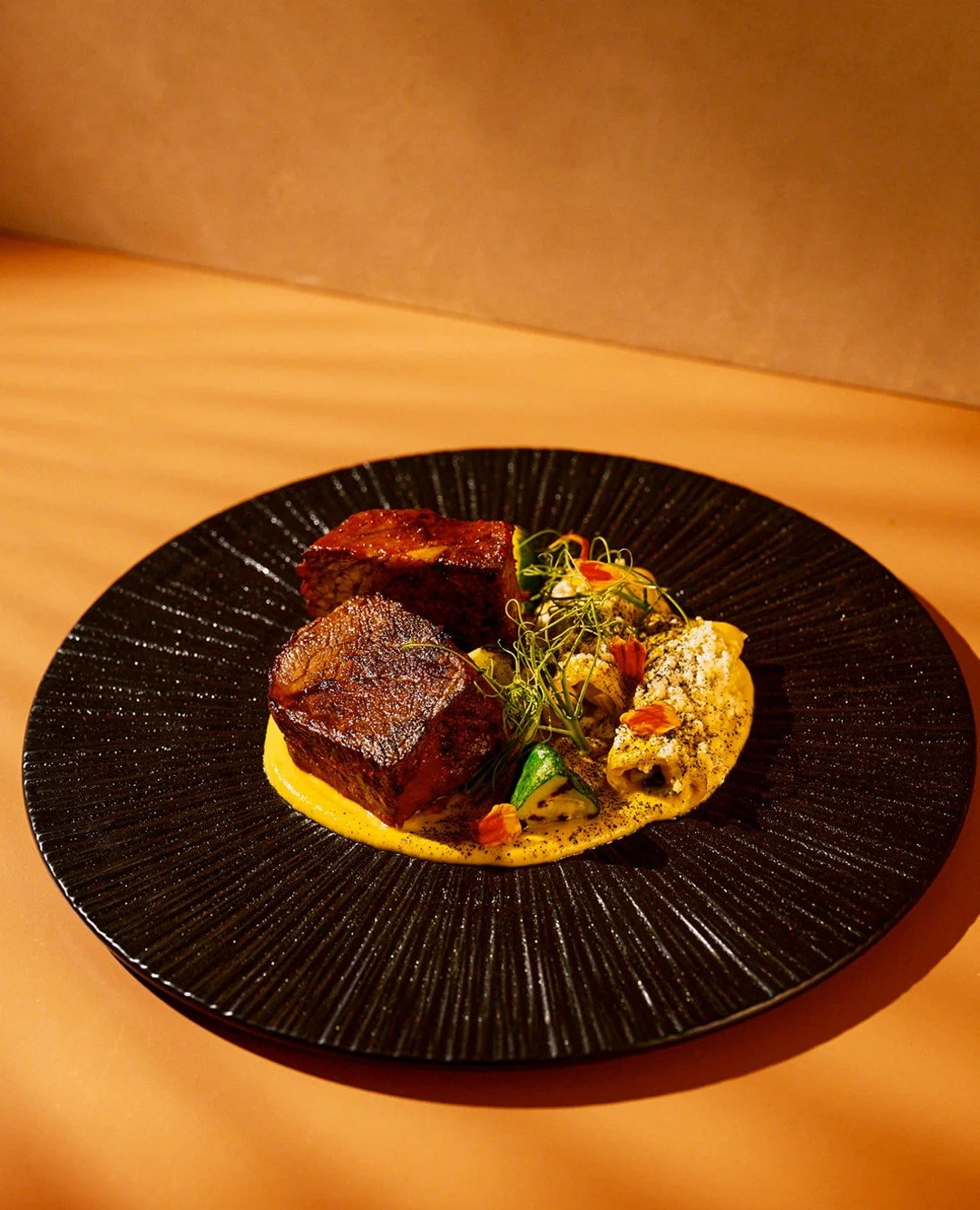 Our Mole Negro Short Rib celebrates the rich, deeply rooted flavors of traditional Mexican cuisine and the ingredients that connect us to the land.

Slow-braised beef short rib, black mole, sweet plantain pur&eacute;e, pickled red onion and sesame co