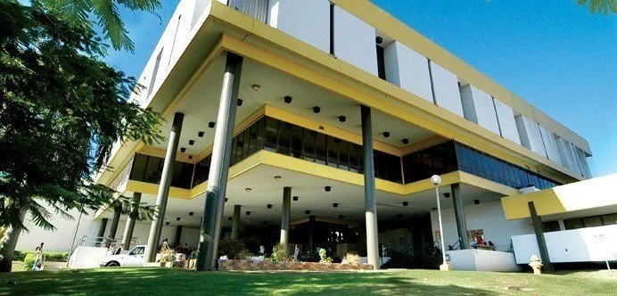 Modern multi-story building with columns and large windows. University of Puerto Rico at Arecibo