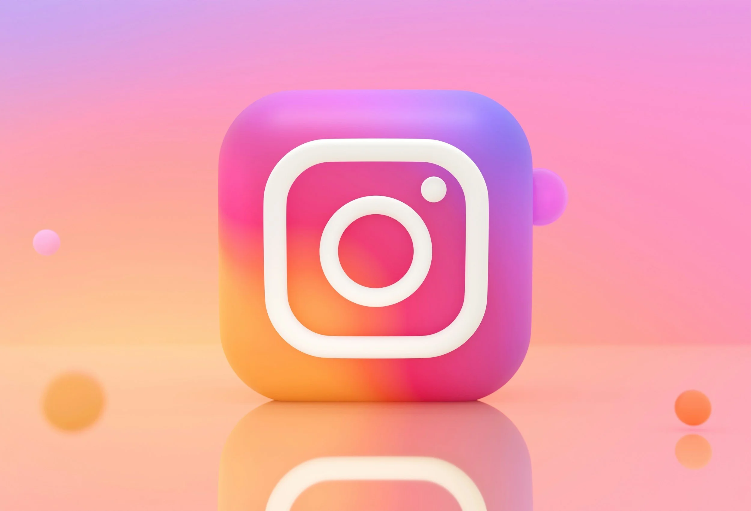 3D illustration of the Instagram logo with a gradient pink, purple, and yellow background and floating colorful spheres.