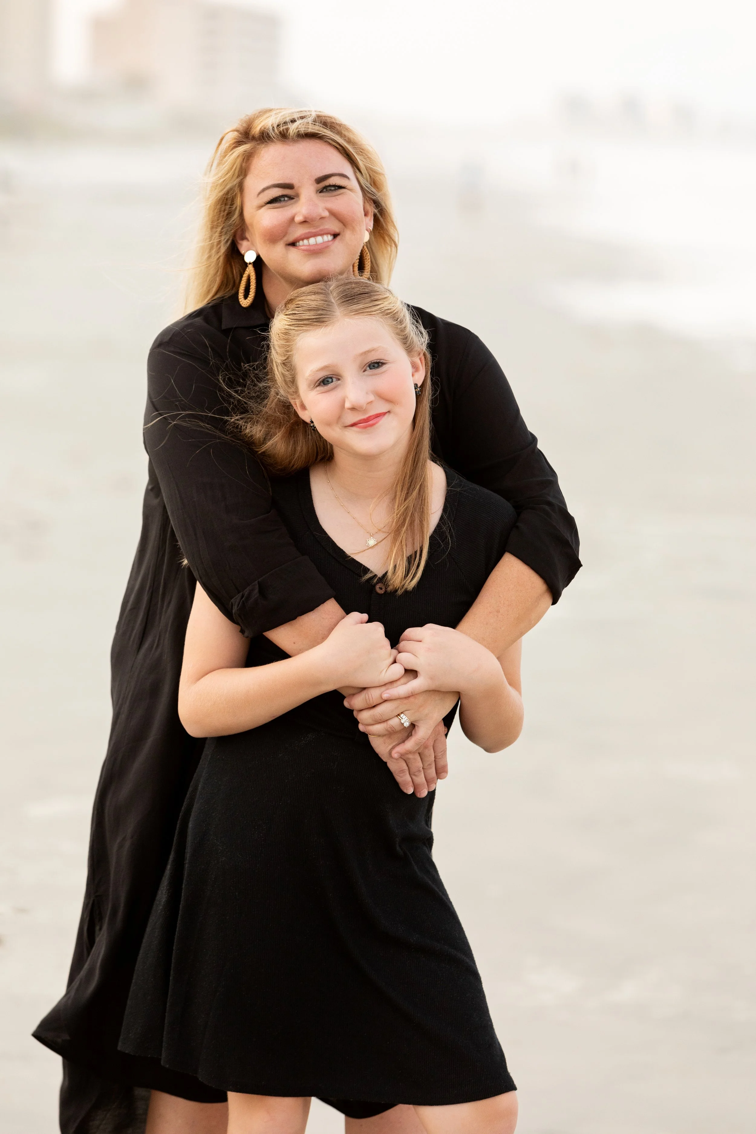 Florida beach family photography of a mother and daughter holding hands along the shoreline