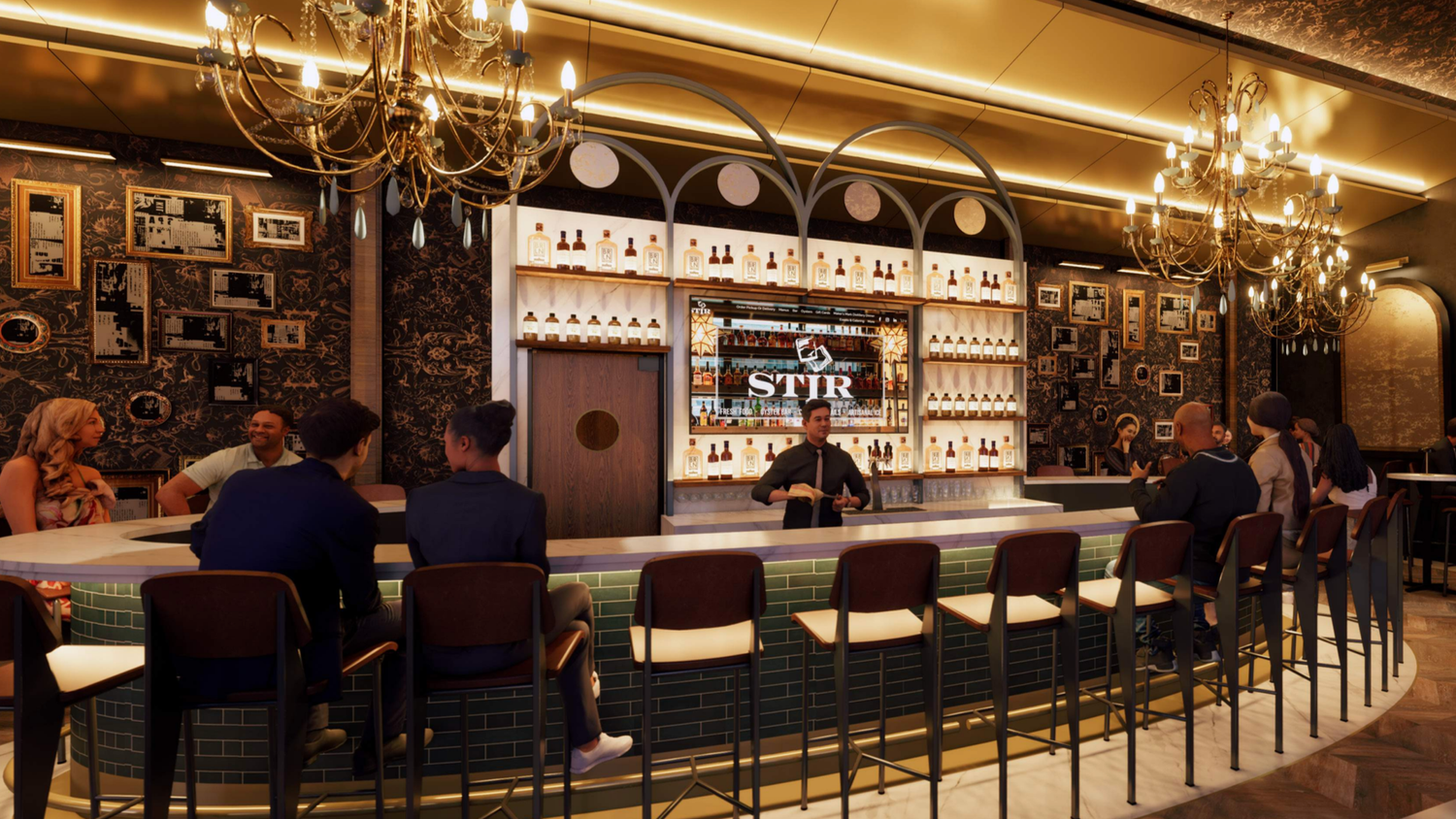 Interior of a bar with a curved marble counter, several bar stools, hanging chandeliers, and a wall decorated with framed photos. Shelves behind the bar display bottles, and a bartender stands at the center, serving drinks. Patrons are seated and engaging in conversation.