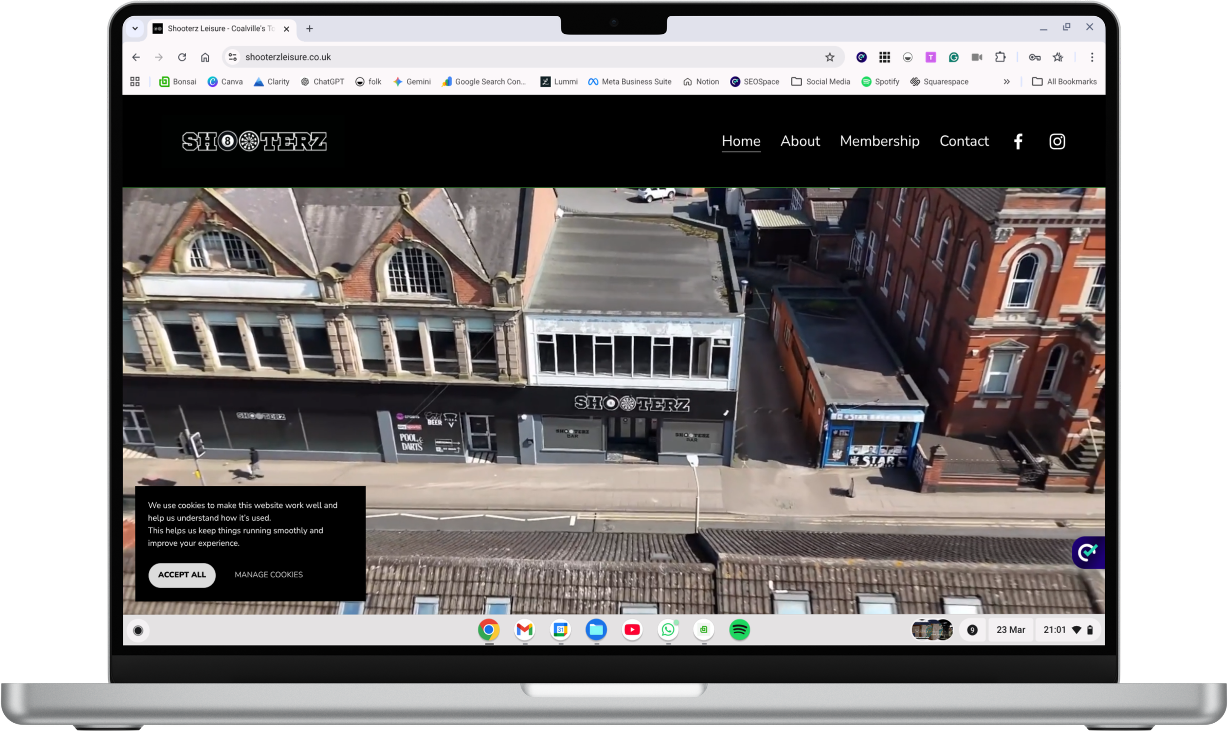 A digital laptop screen displaying a website with a background of shelves filled with various bottles, including liquor bottles, with a logo of a tennis racket and ball in the center of the shelf.