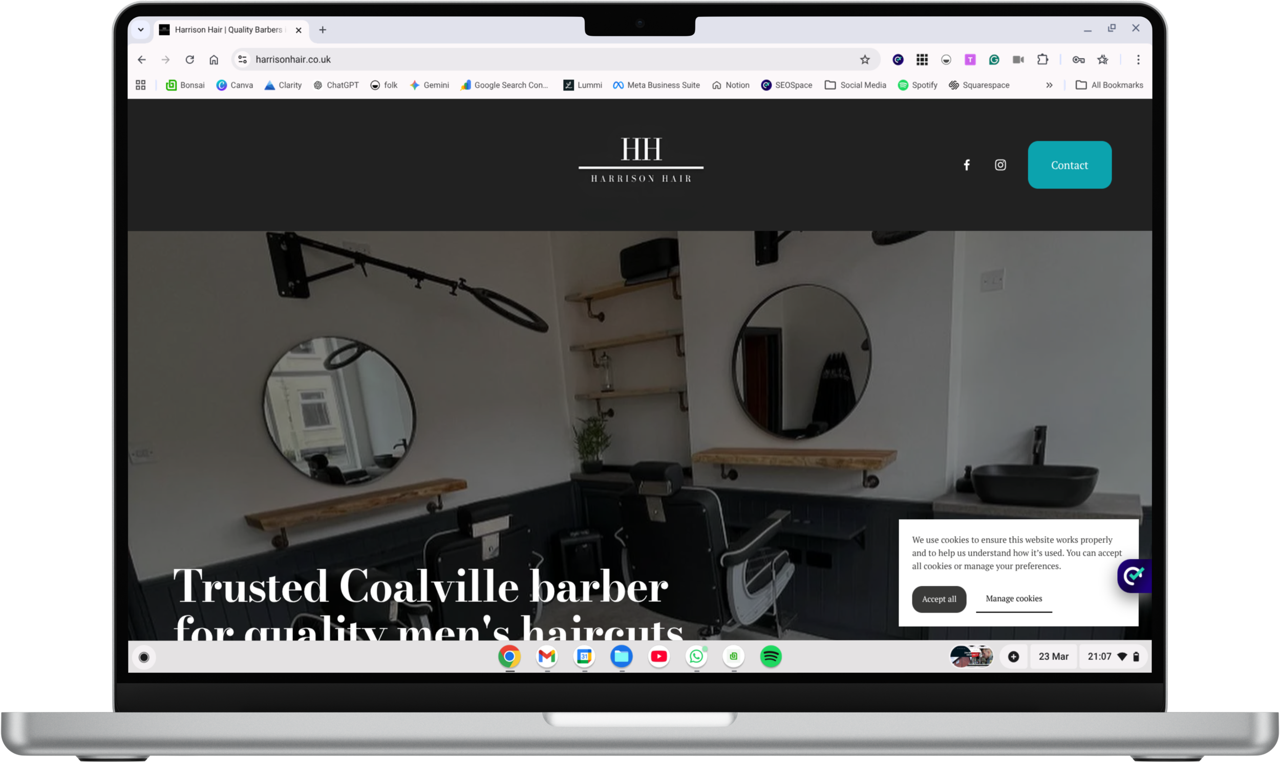 Interior view of a barbershop with two vintage barber chairs, mirrors, wooden shelves, and a black vanity with a basin sink, promoting men's haircuts and grooming in Coalville.