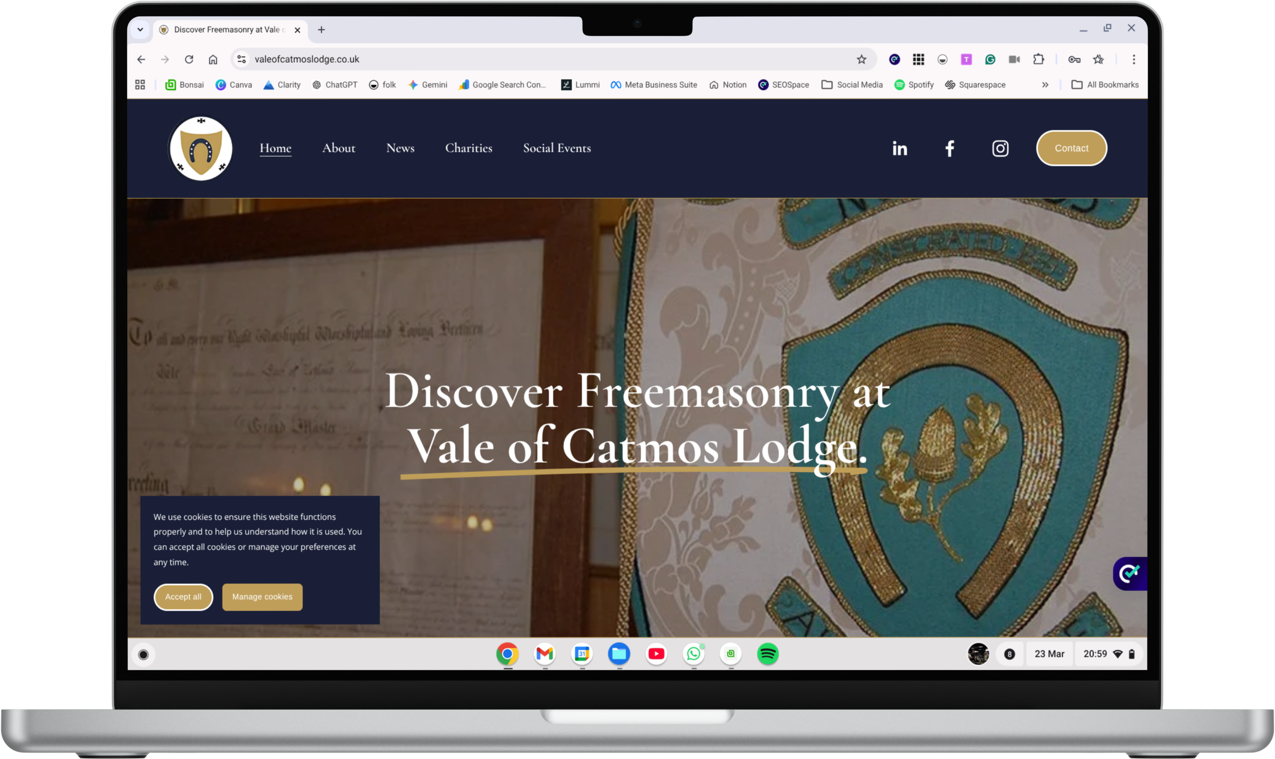 Laptop screen displaying a website with text "Discover Freemasonry at Vale of Catmos Lodge" and a large embroidered Masonic emblem on the right side.