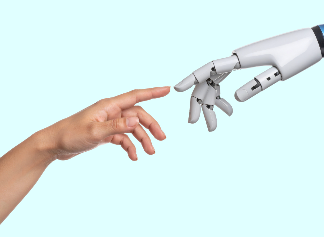 Human hand reaching to touch the finger of a robot hand