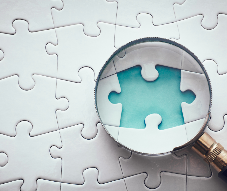 a magnifying glass on a missing puzzle piece