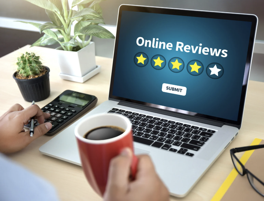 Man at a computer reading online reviews