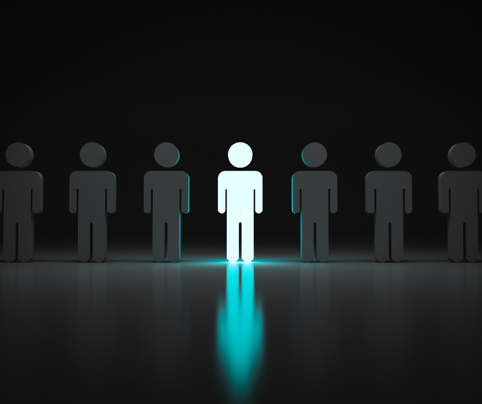 one person standing out among several with a light over them