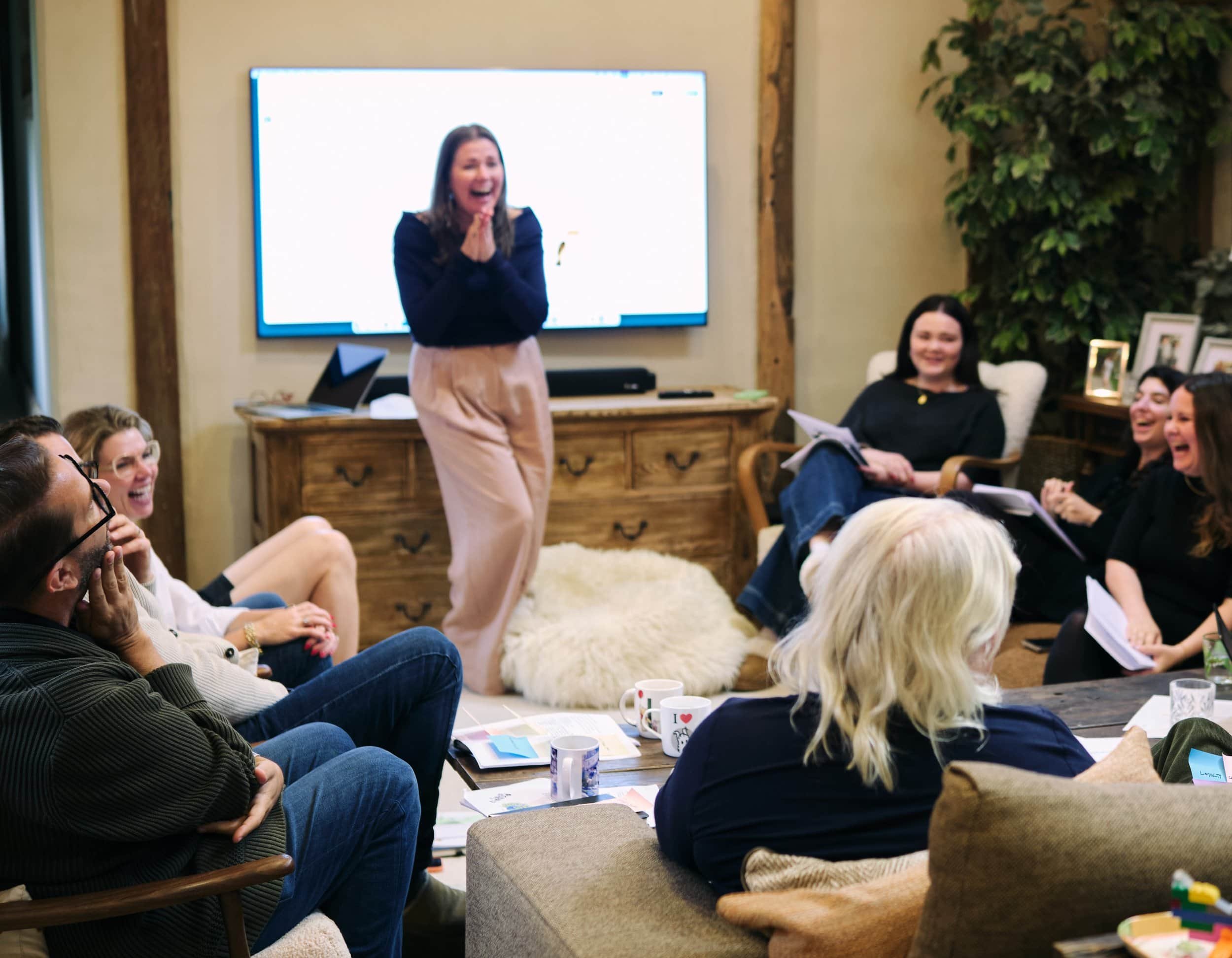 Coach giving presentation in front of a group of clients