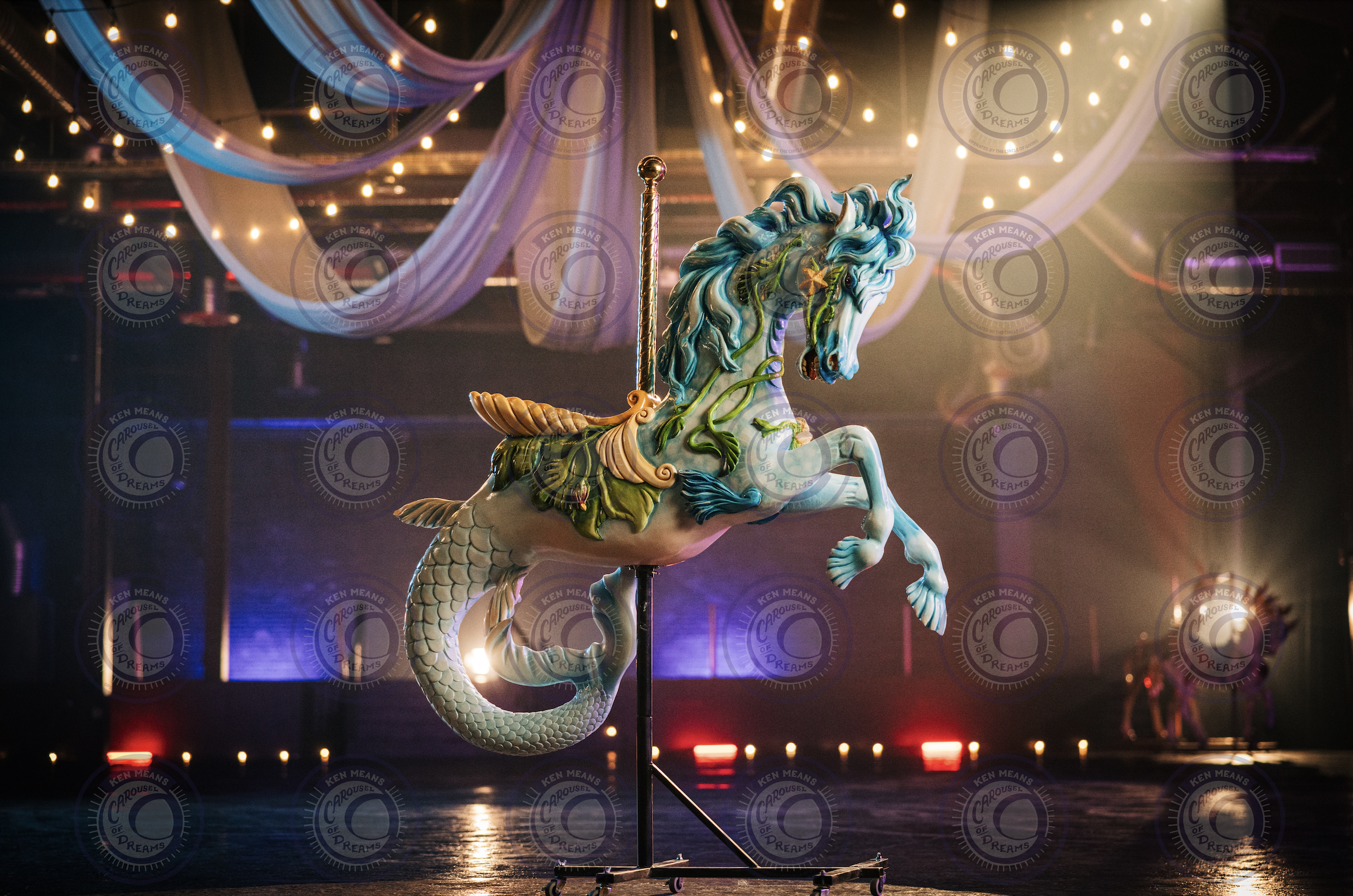 A decorative carousel seahorse under a dimly lit ceiling with draped fabric and string lights in an indoor setting.
