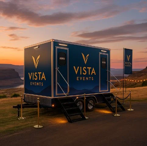 Blue Vista Events trailer with stairs and rope barriers outdoors at sunset.