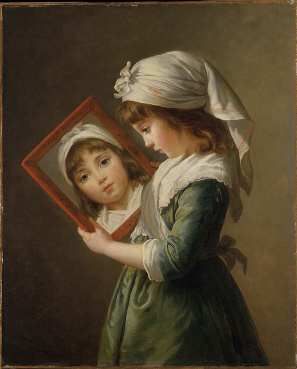 A girl dressed in historical clothing holds a framed mirror reflecting her face.