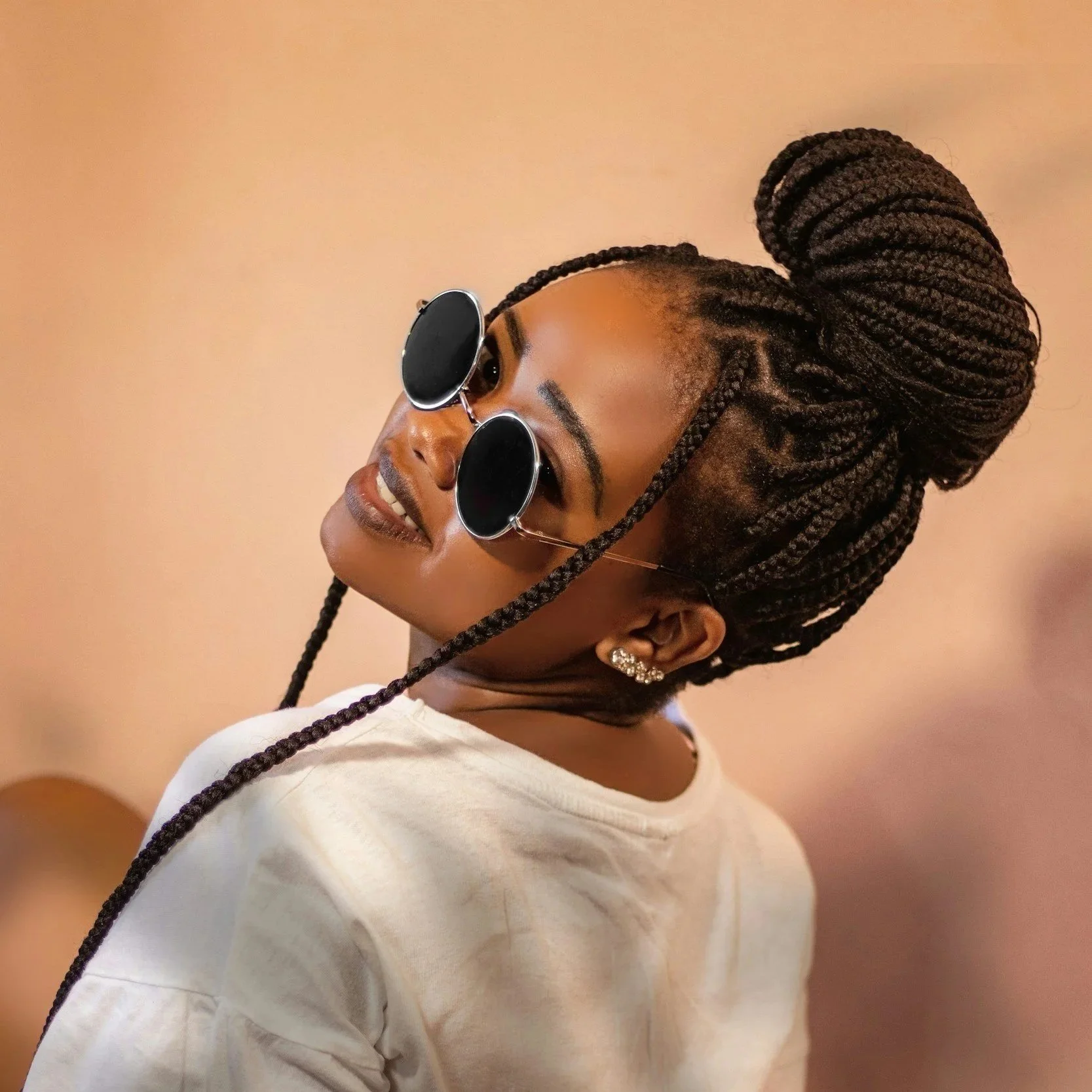 A woman with braided hairstyle in a rental salon suite in Brooklyn Park.