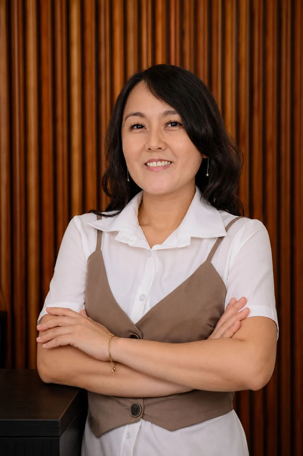Nadia smililign and looking confident with her arms crossed