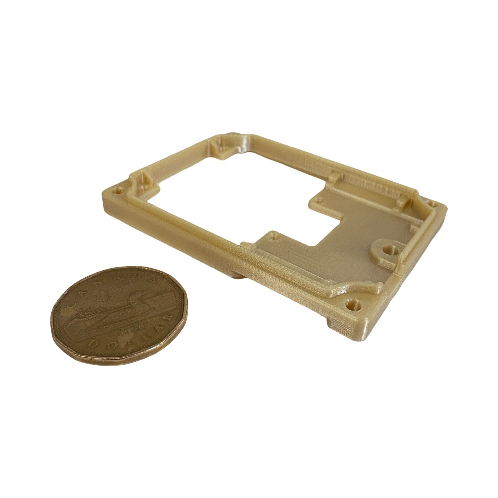 thin wall ultem 9085 frame printed on stratasys fortus production system beside canadian loonie for scale