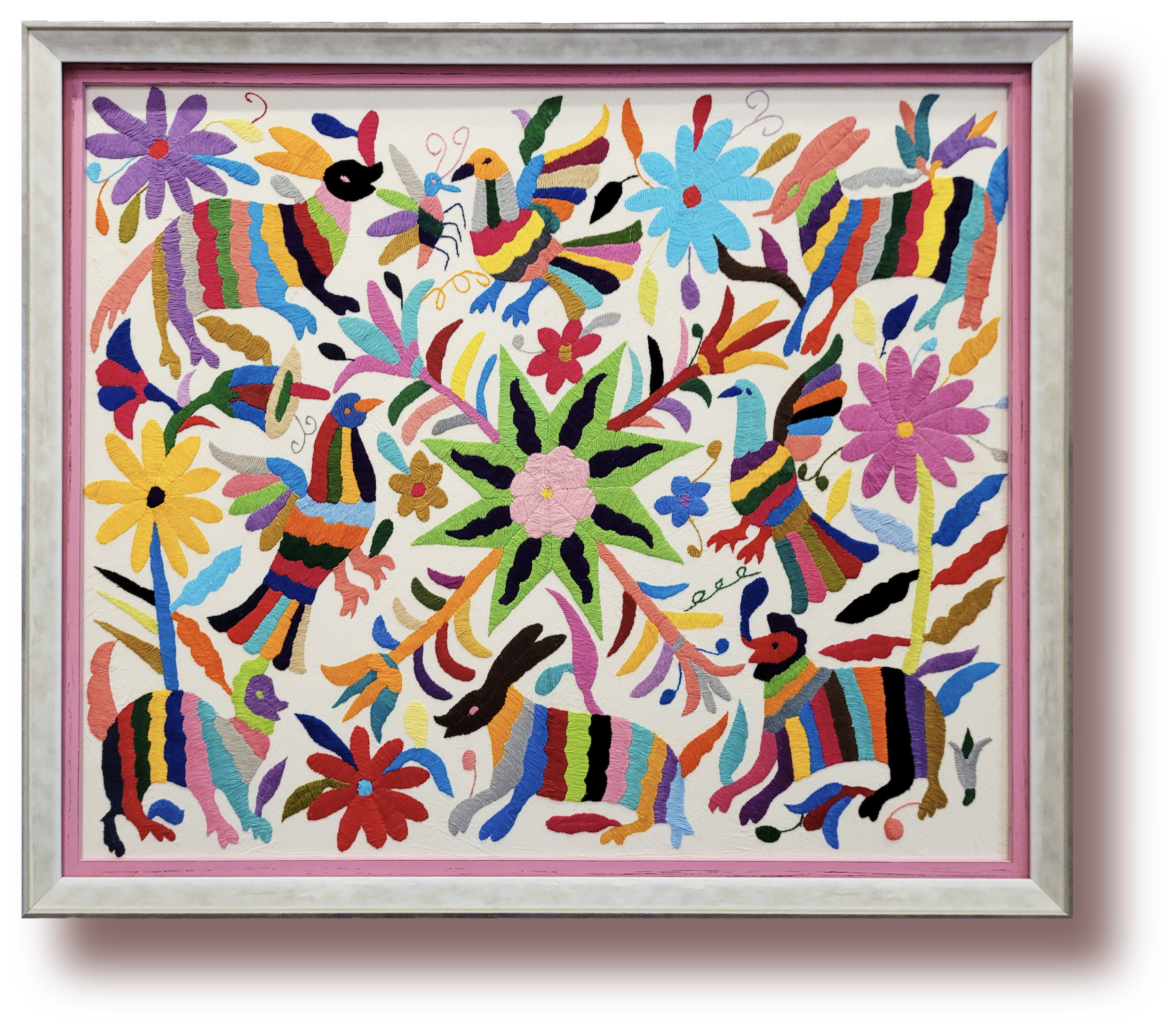 Colorful embroidery artwork featuring birds, animals, and flowers with a central flower design, framed in a white and pink frame.
