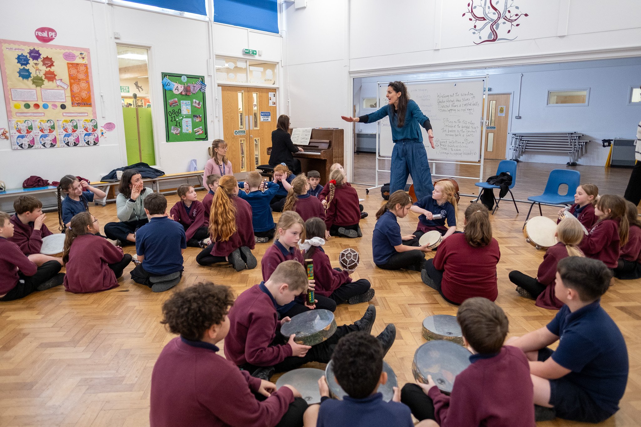 Teacher and pianist in a class room setting with children