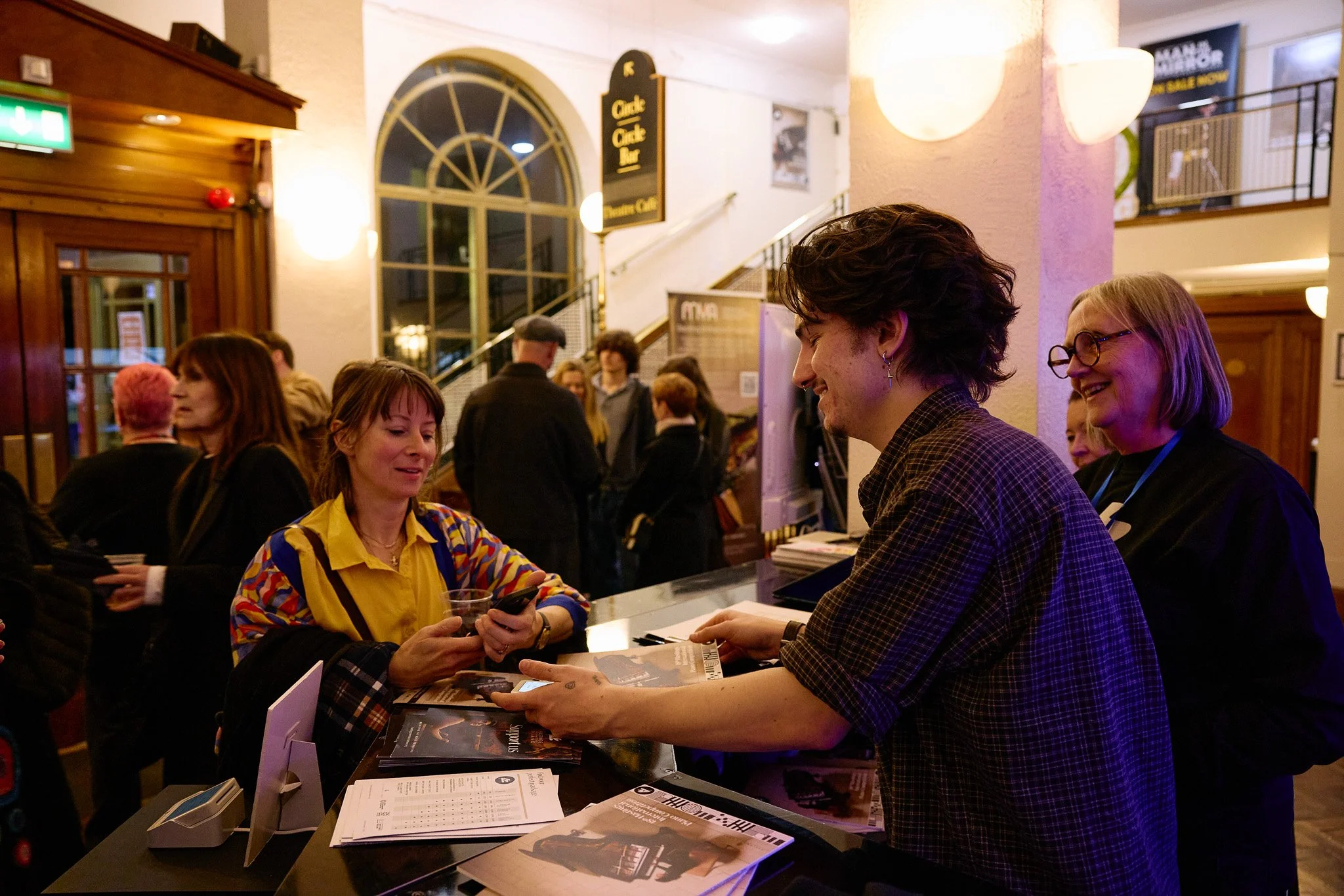 Intern working behind a merchandise stand at a concert