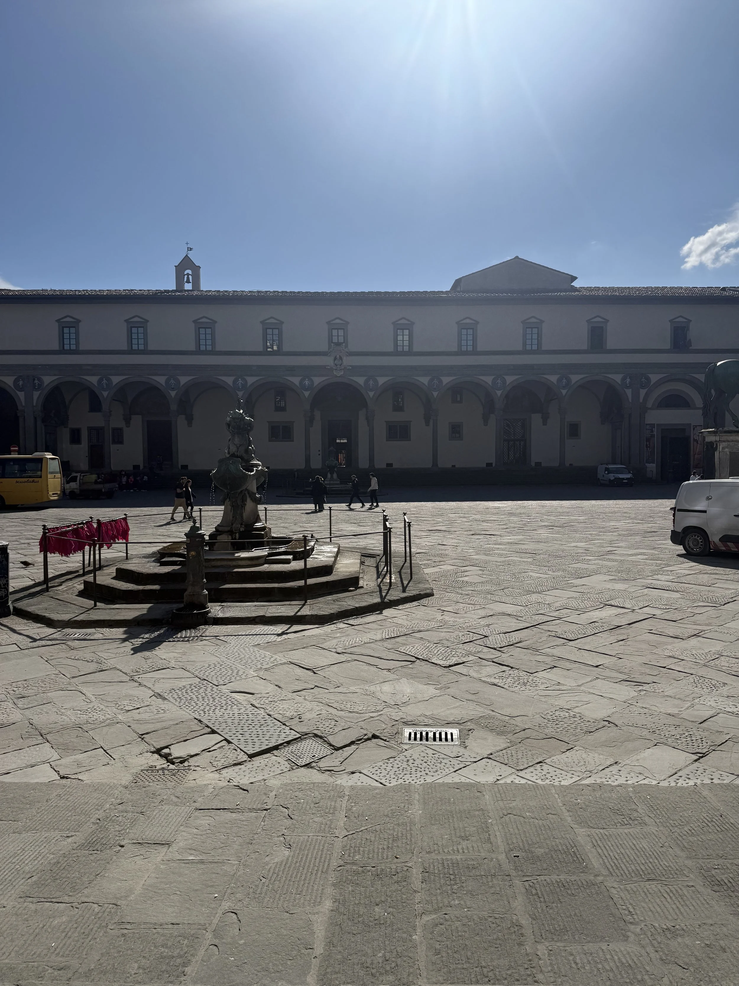 Piazza Santissima Annunziata, Florence. Brunelleschi's loggia for the Ospedale degli Innocenti, commissioned in 1419 and often called the first Renaissance building. The della Robbia roundels of swaddled babies came about seventy years later.