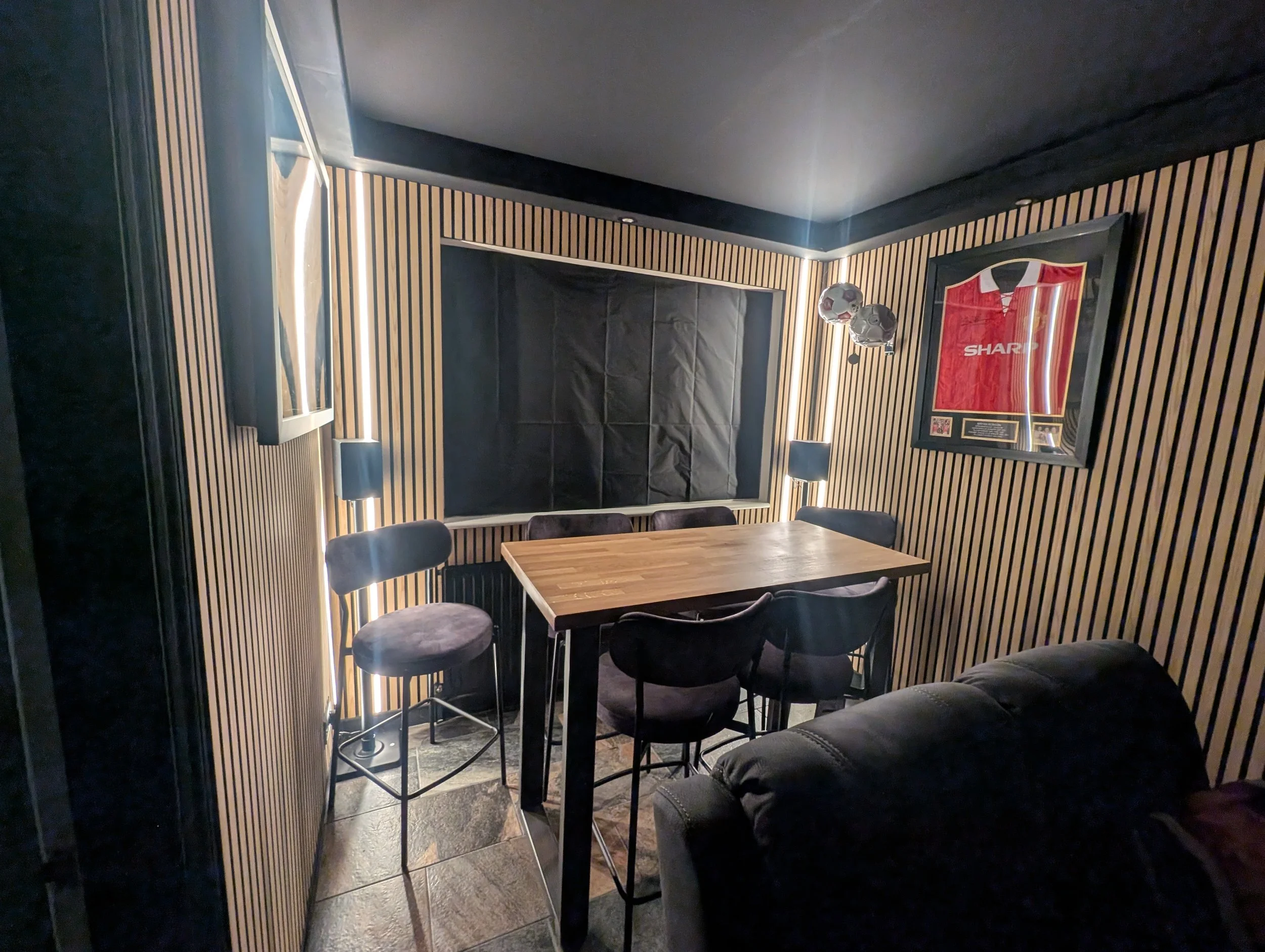 Cinema room installation with LED slat lights, uplights and perimeter downlights in Oxford