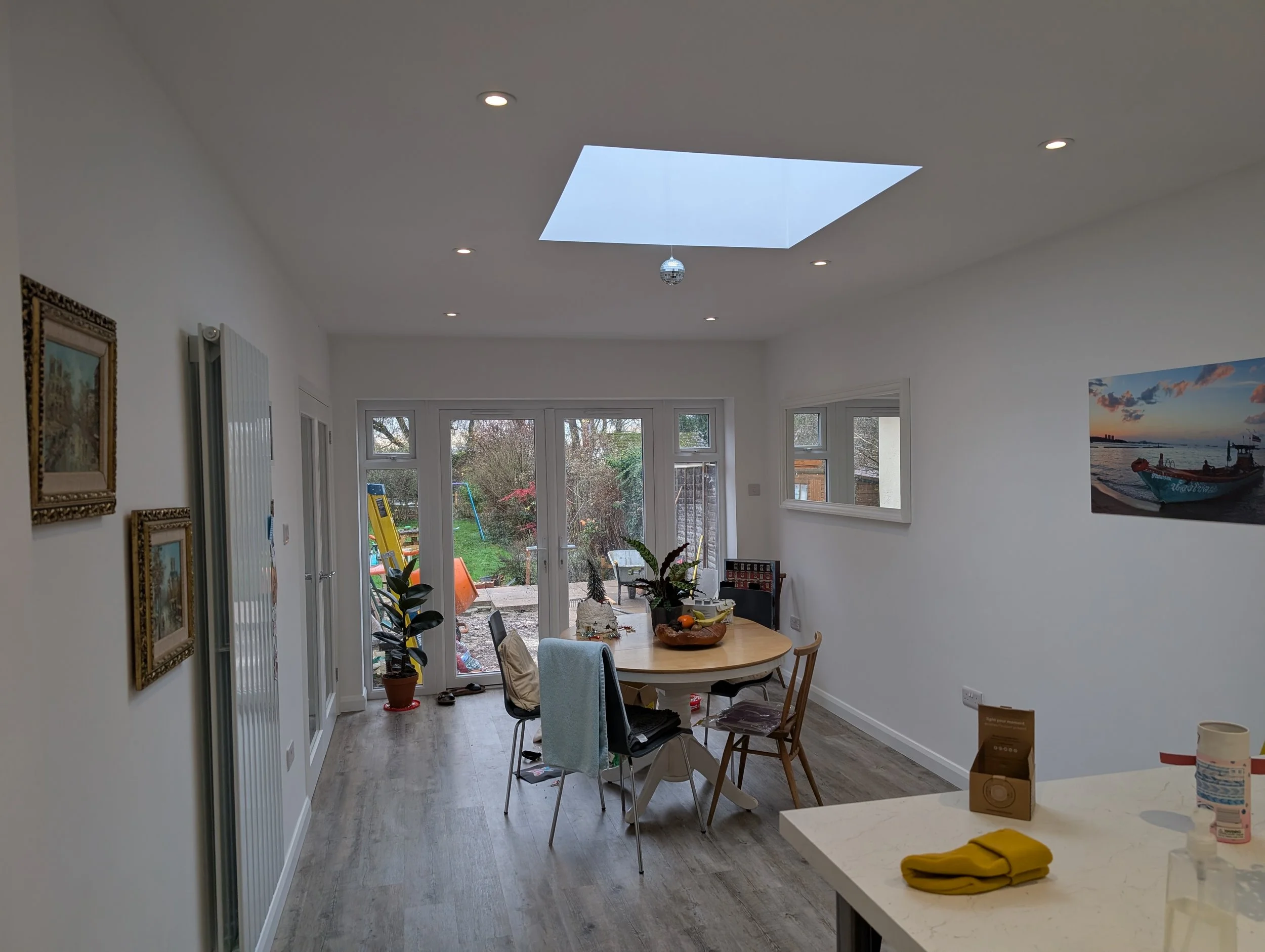 Extension and existing kitchen rewired with Collingwood downlights, new power and LED strip lights undercabinet, integrated with smart Quinetic wireless switching and dimming.