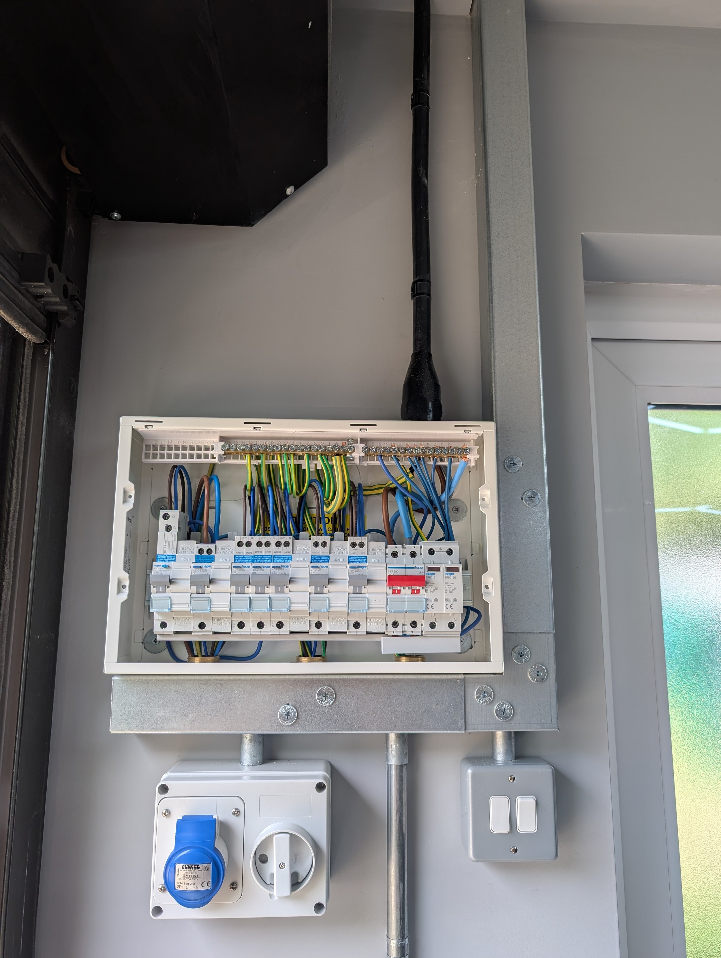 Steel trunking and fuseboard in commercial garage in Oxford