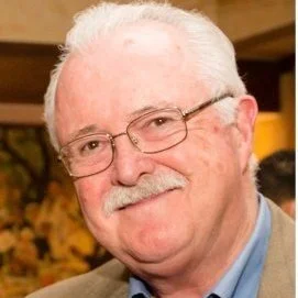 Smiling elderly man wearing glasses and a mustache