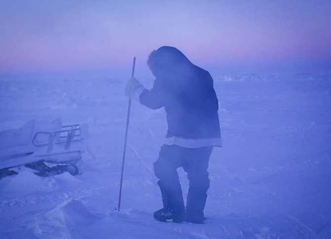 Inuit hunter in the midst of polar night.