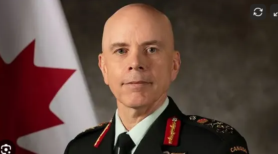 Portrait of a man in a Canadian military uniform with a Canadian flag in the background
