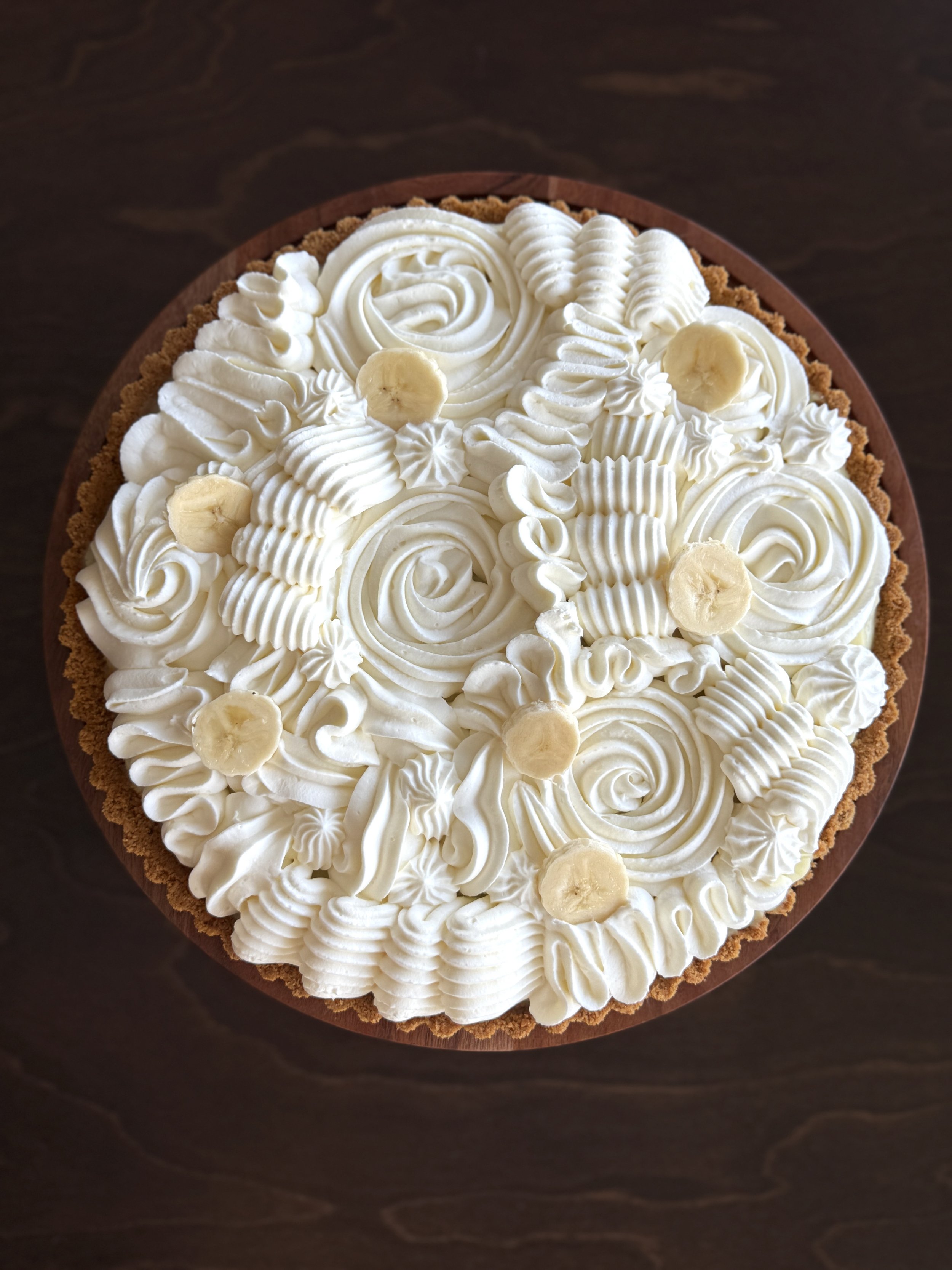 The Wild Whisk Bakery banana cream pie topped with fresh bananas