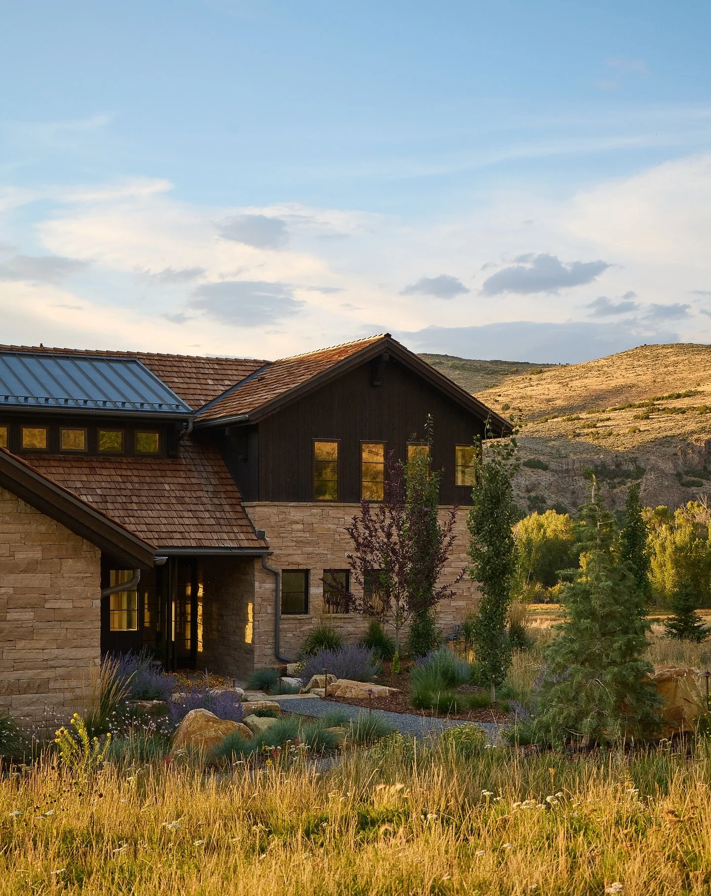 Utah Sky / This home set into the Utah landscape has low slung and stretched out proportions which nestle it into the site. The natural materials that clad the home meld with the surrounding hills and mountains contrasting the ever-changing Utah Sky.